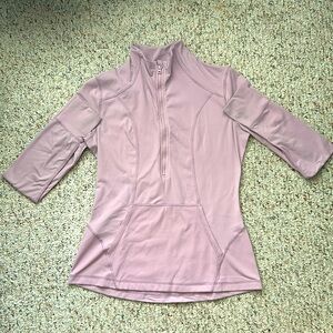 Lavender half zip yoga jacket with center pocket and thumb holes